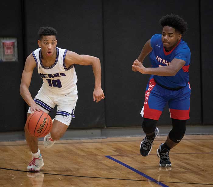 2 students playing basketball